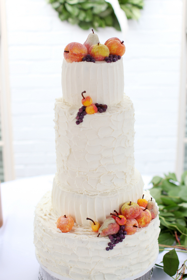 Ivory-colored wedding cake topped with fruit - Wedding Photo by Whitebox Weddings